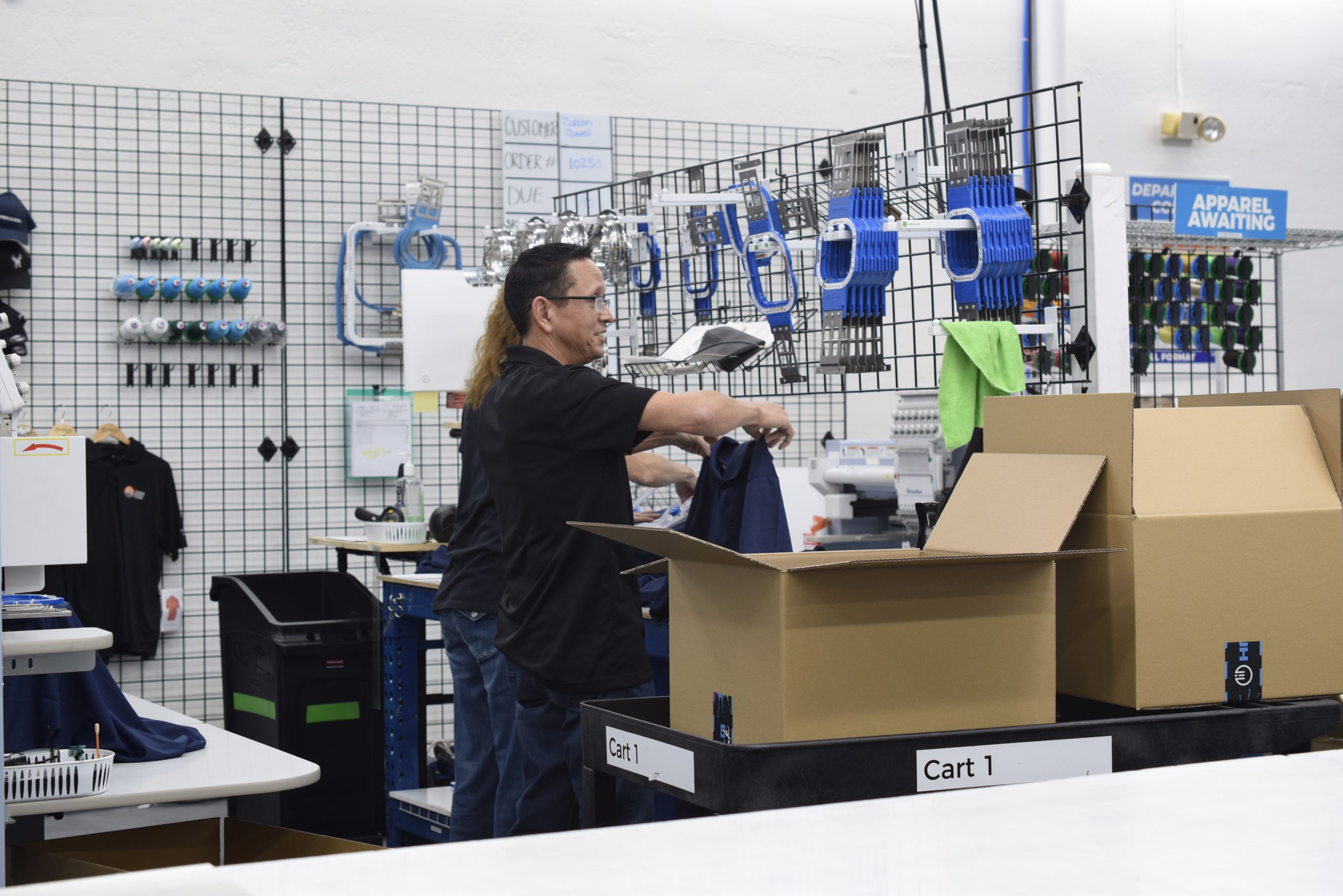 Founder Jeff Hale folding shirts in the embroidery department at Halo Ink. 